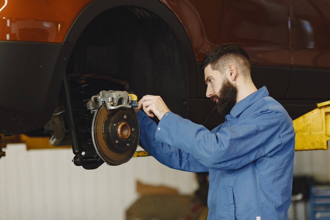 Mechanic inspecting a vehicle brake rotor